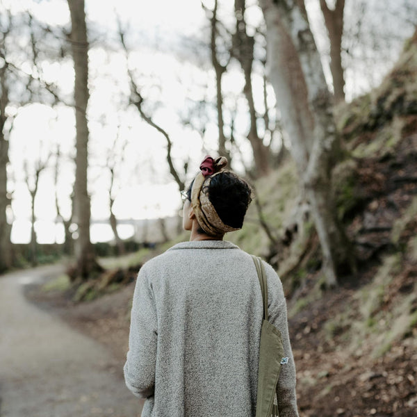 Scottish life coach Nadia Karim walks along path through forest
