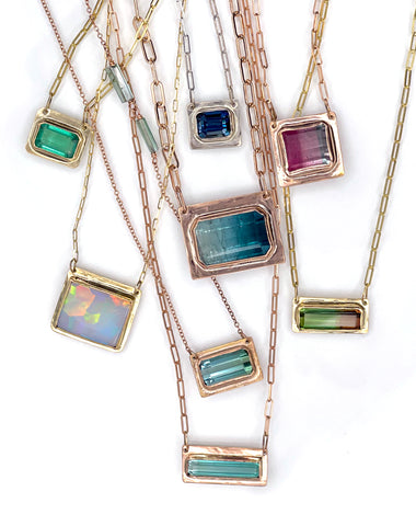 8 tourmaline necklaces in 14K Solid gold on a white background