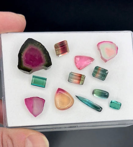 various colored tourmaline gemstones in a white box