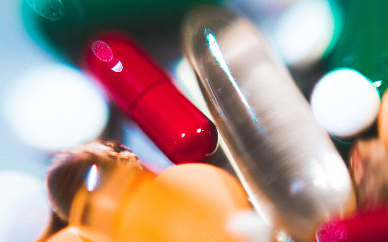 A close up, hazy photo of several probiotic pill supplements.