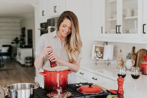 Woman cooking & how to reduce stress by elevating small moments