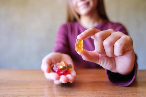 Woman with gummy in hand