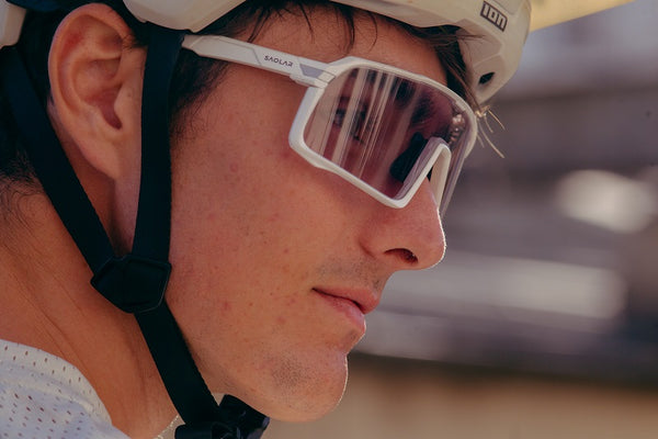 Mountain biker wearing transparent, photochromic cycling glasses demonstrating effective night vision and lens transition in low light conditions.