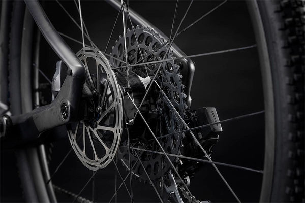 Image showing the detailed process of wheel maintenance as part of a bike tune-up, highlighting tools and techniques for inspecting and caring for bicycle wheels and tires.