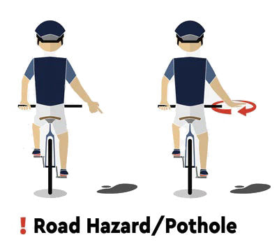 Cyclist pointing downwards to indicate a pothole or road hazard ahead.