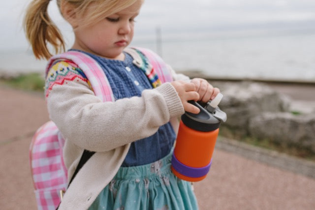 Kid with bottle band on water bottle