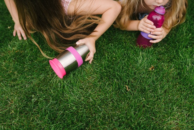 kids, grass and water bottles with bottle bands