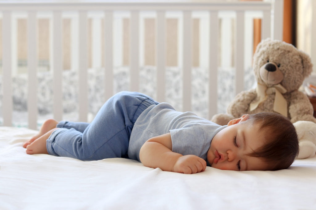 kid sleeping on a bed