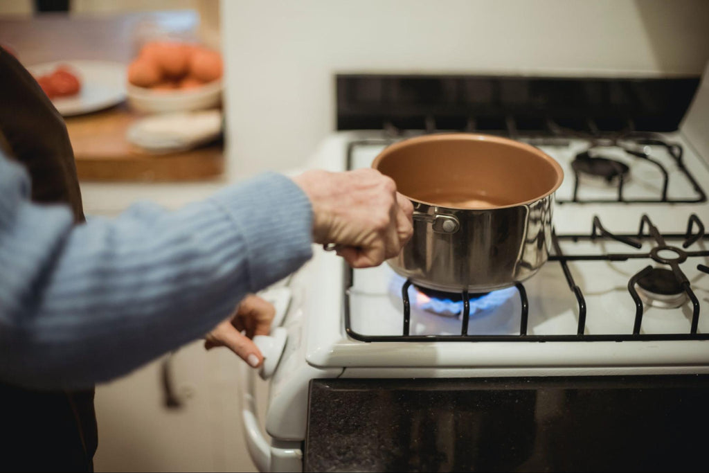 Person bringing the water to a rolling boil