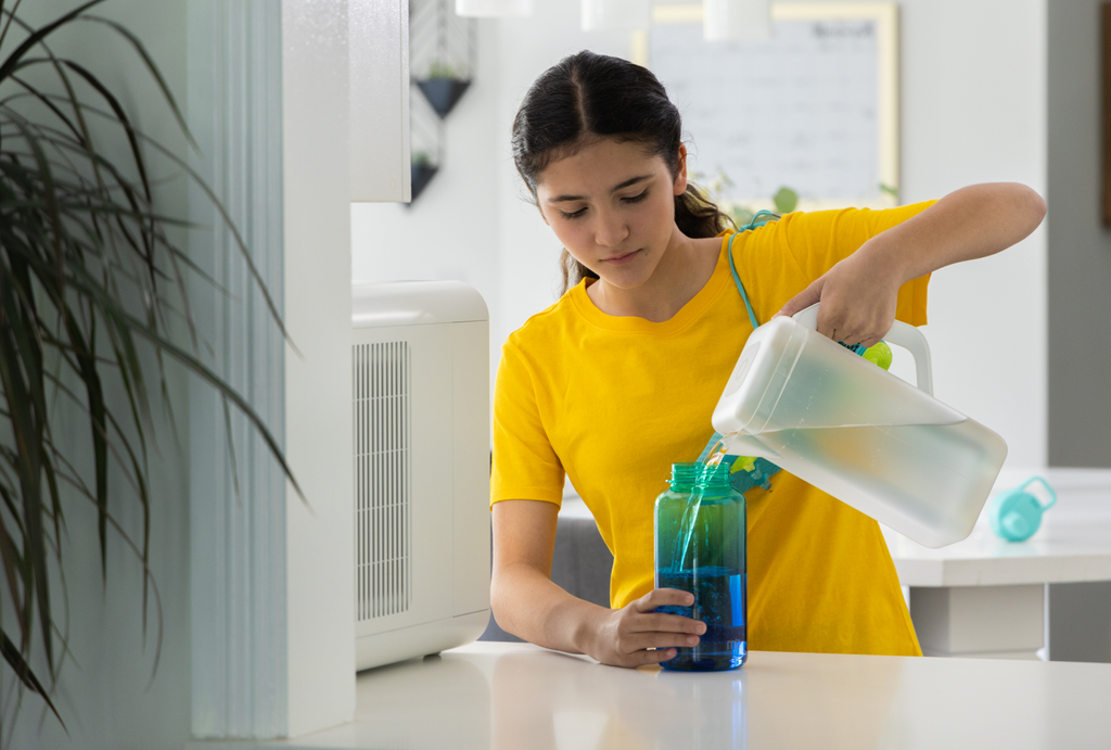 Women pouring water into a cup from her Spout AWG