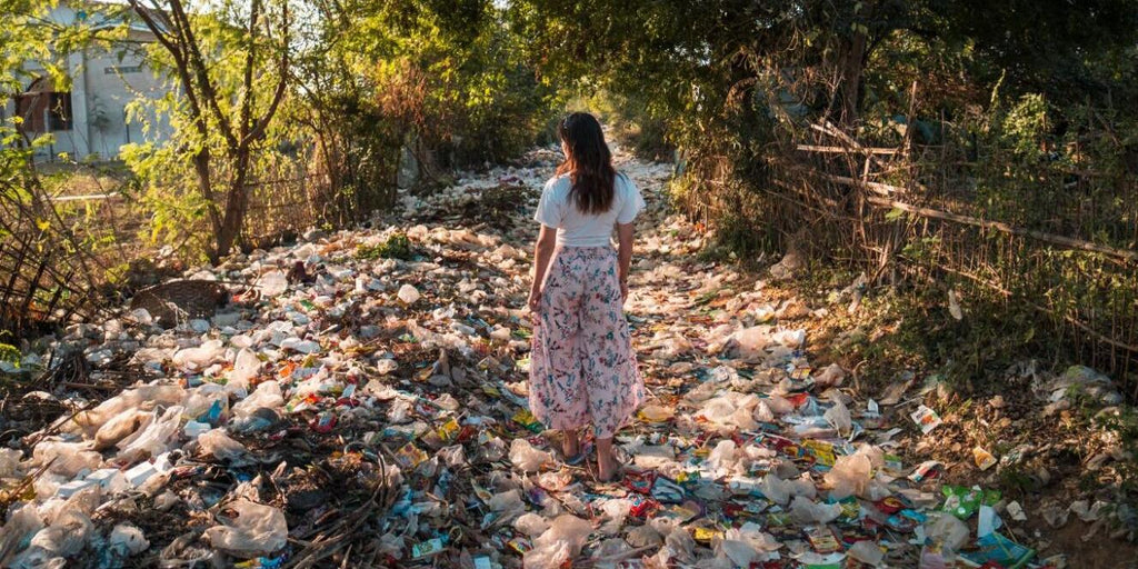 Women walking through plastic waste