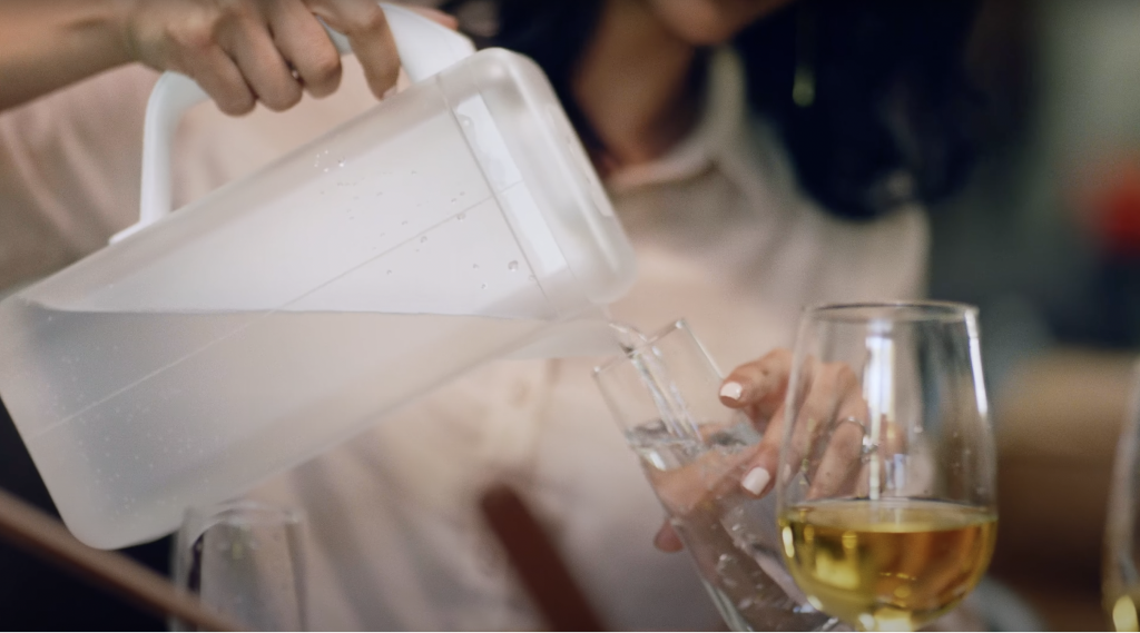 Women pouring water from the Spout pitcher