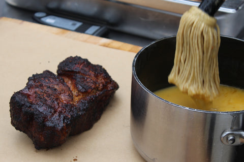 Mopping BBQ butter on Carolina BBQ Beef