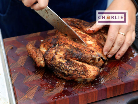 Cutting up the chicken to dip into the cajun blackened butter