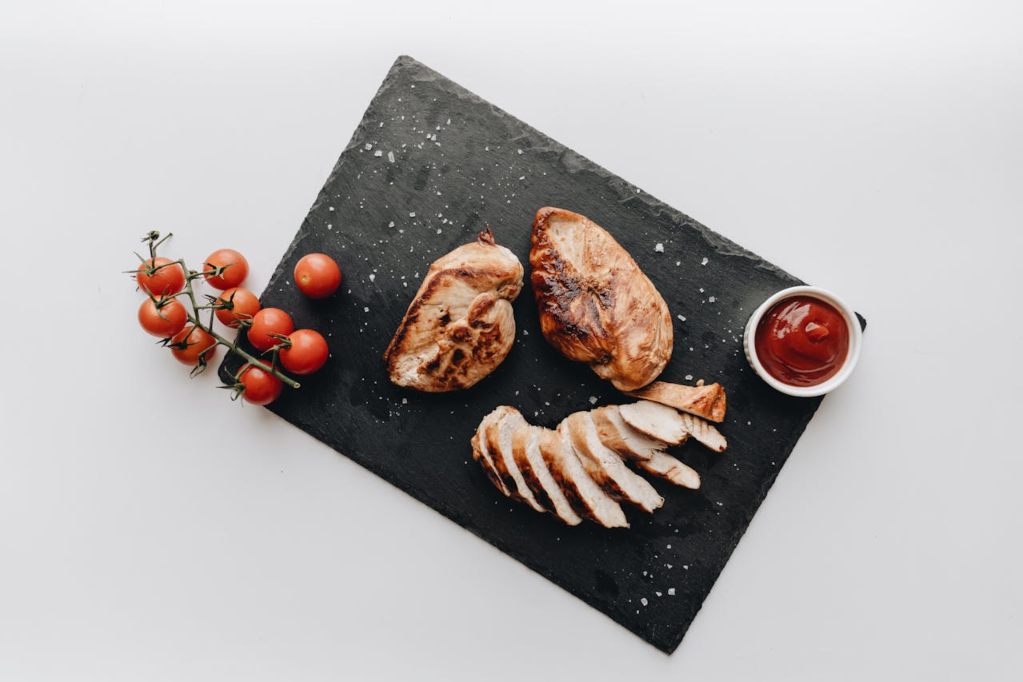 Seared chicken breasts on a slate cutting board