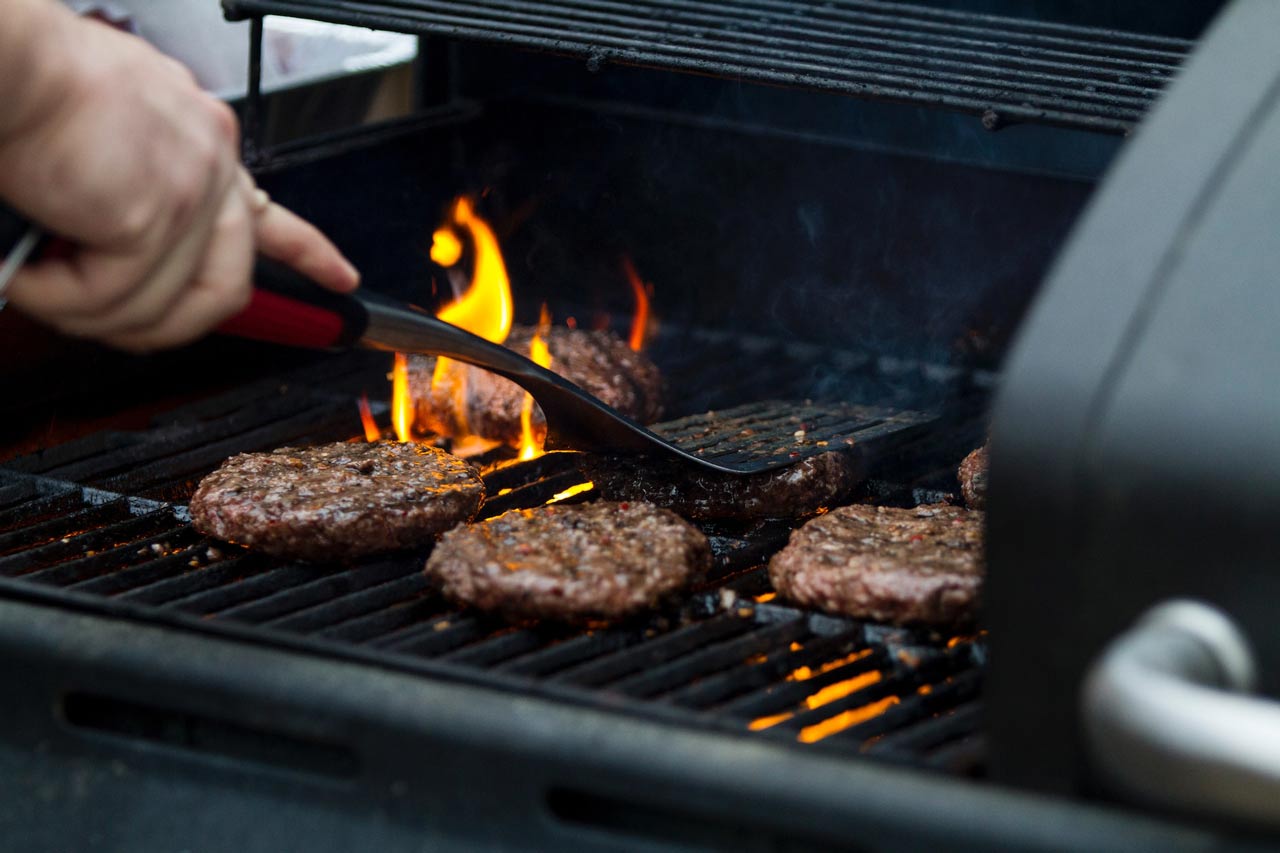 A person grilling burgers