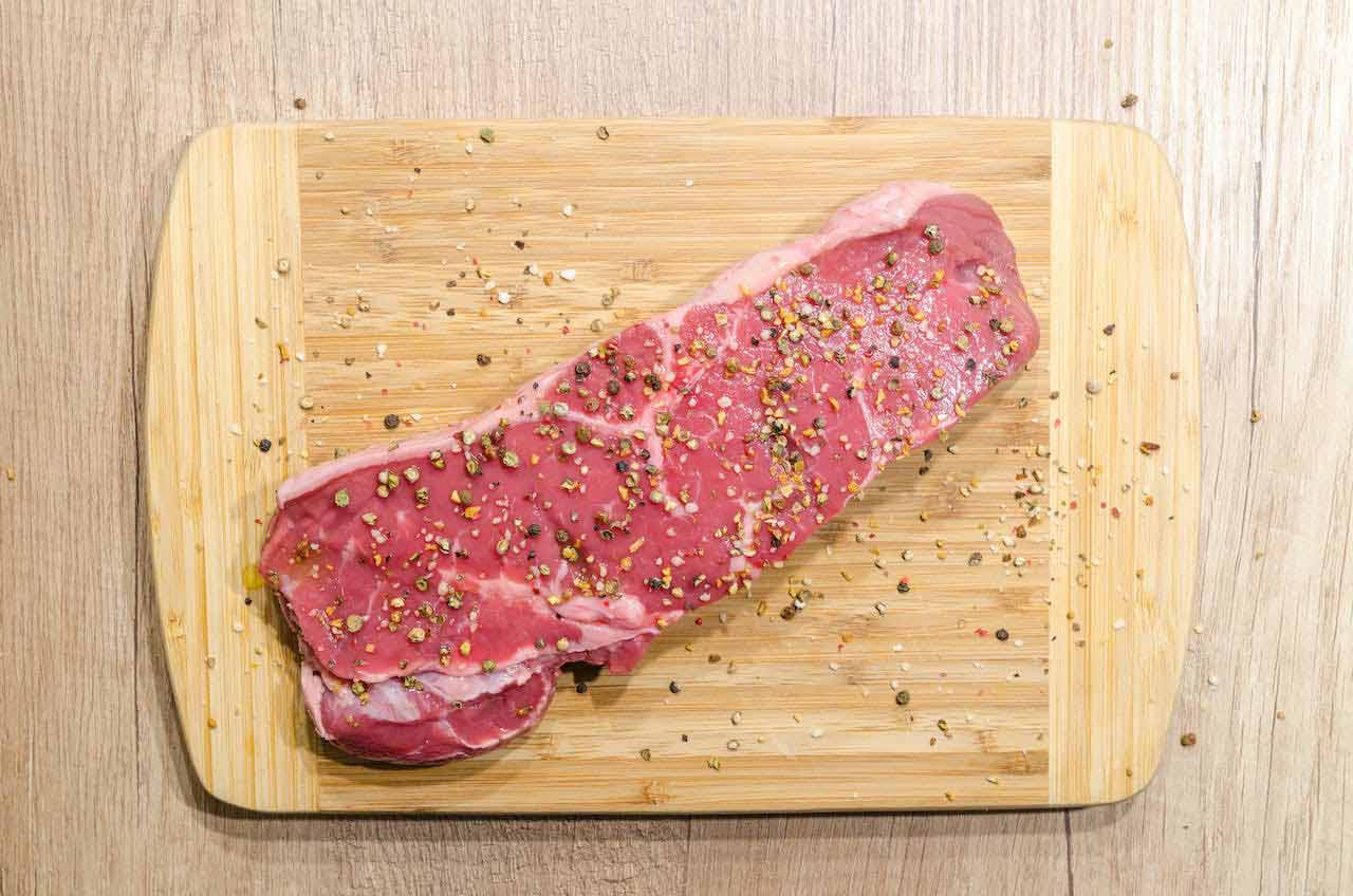 Seasoned steak on a cutting board