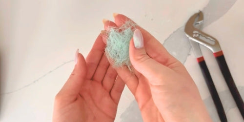 Pile of bristles from bamboo toothbrush in a womens hands