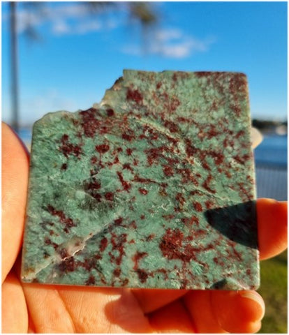 australian bloodstone slice held in the air