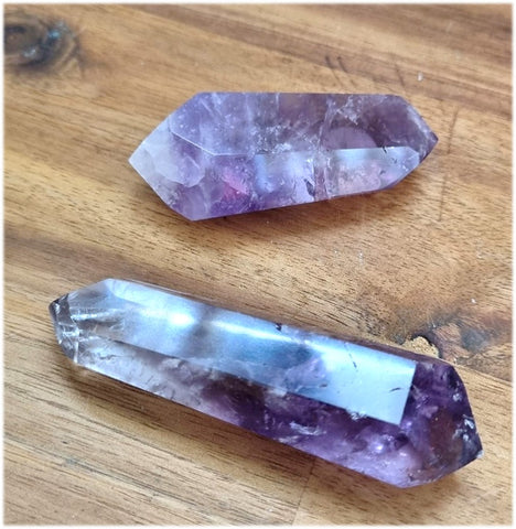 double terminated amethyst points on table