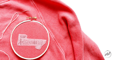 Embroidering a sweatshirt using water-soluble stabilizer.