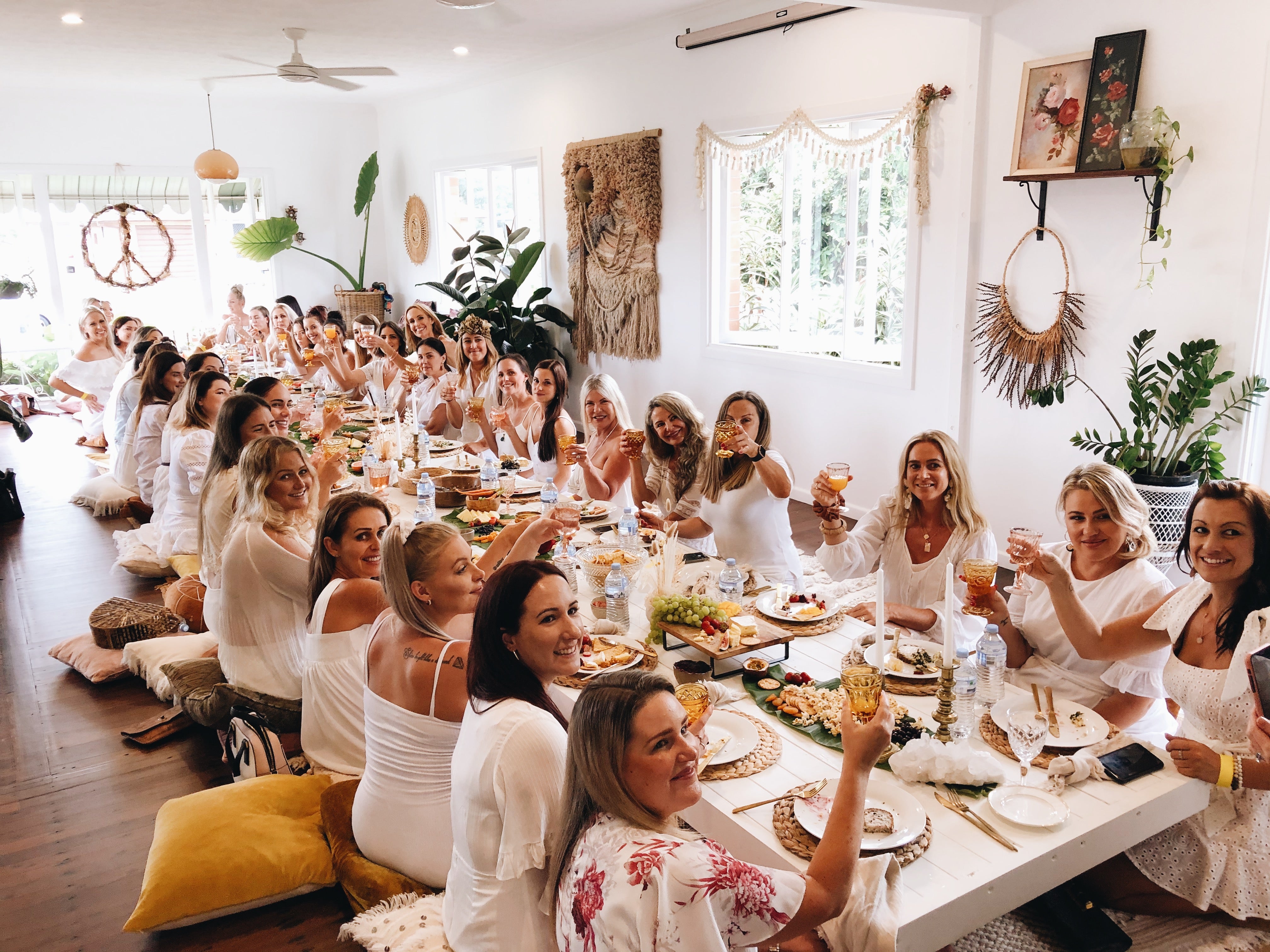 Long table of girls enjoying drinks and food and craft party