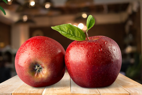 An image of two apples, one of the high fiber foods, in the table.