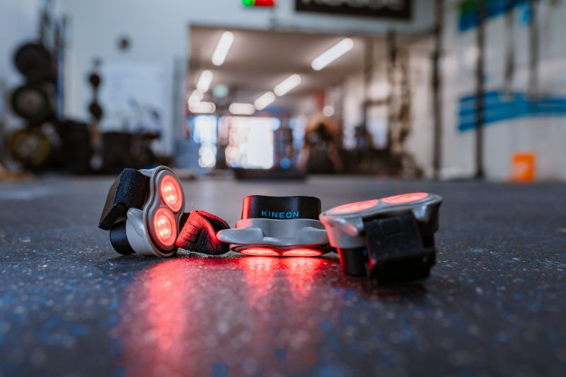 Kineon Move+ Pro red light therapy device on gym floor