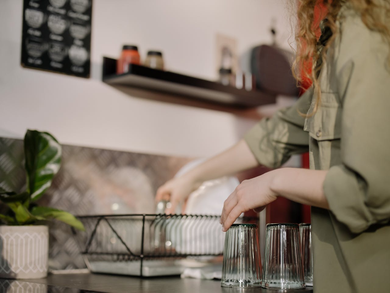 An image of a woman washing dishes.