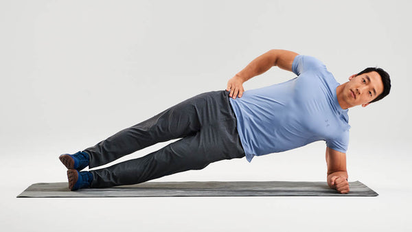 An image of a man doing side planks.