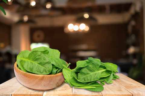 An image of a spinach, one of the high fiber foods, set on the table.