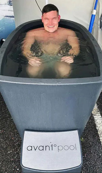 smiling man soaking in an ice bath