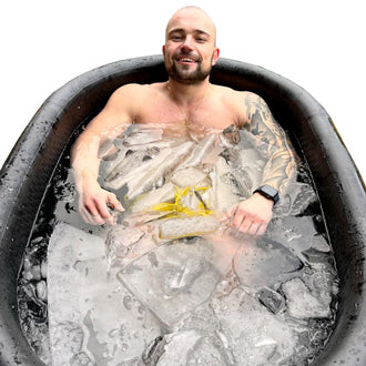A man smiling inside an ice bath