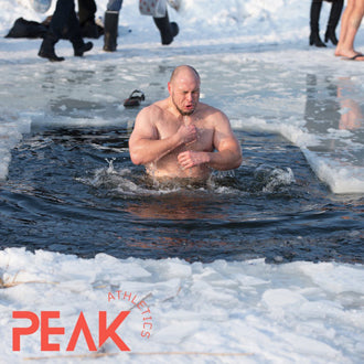 A man inside an ice hole made on a winter lake