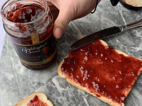 spreading boddingtons jam on toast