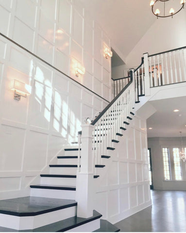 Staircases with sconces and chandelier