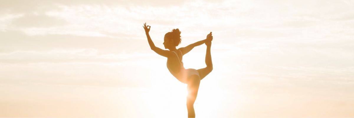 a girl doing yoga in sunset