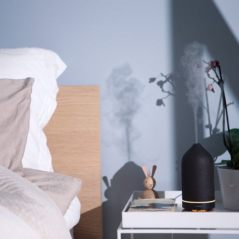 bedside table with a diffuser