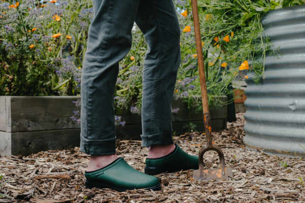 Man standing in garden wearing Alpine Green clogs