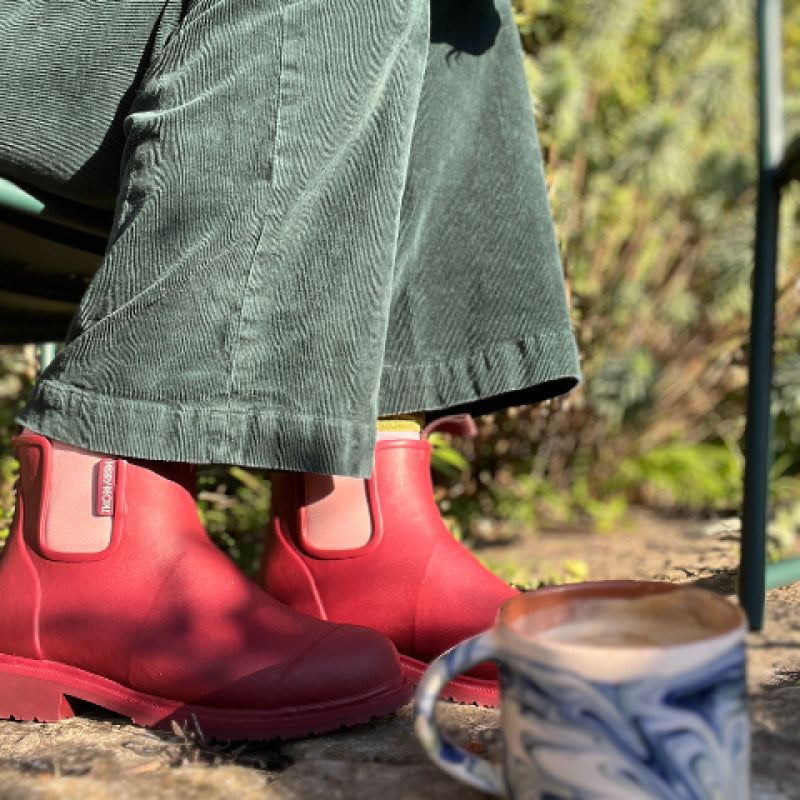 a shot of red merry boots and black jeans