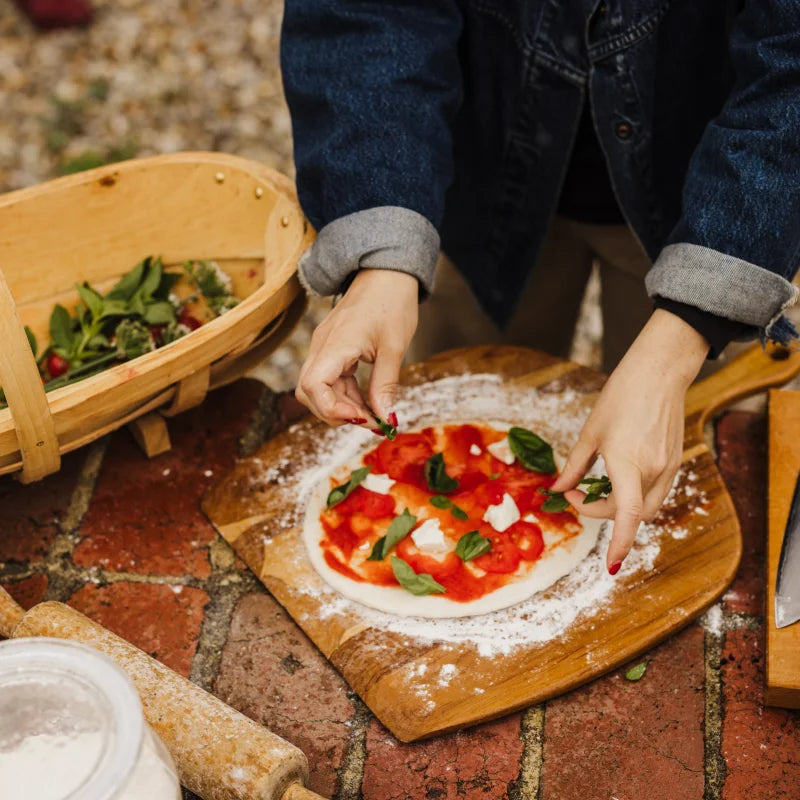 adding veggies to the pizza