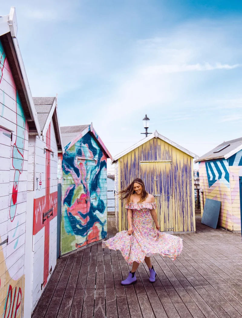 ashley wearing a dress and lavender boots