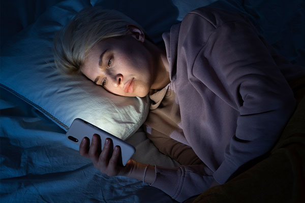 insomnia-sleepless-disorder-women-can-not-sleep-uses-her-phone-in-bed