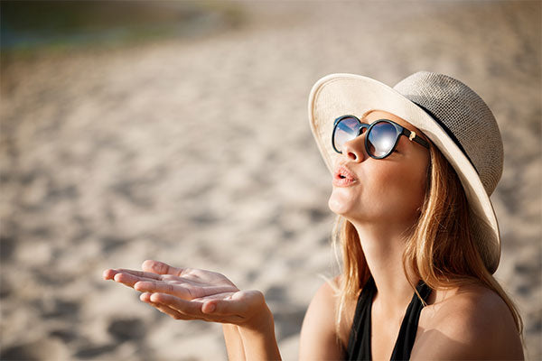 beautiful-young-cheerful-girl-wearing-glasses-hat-rests-morning-beach-sun-protection