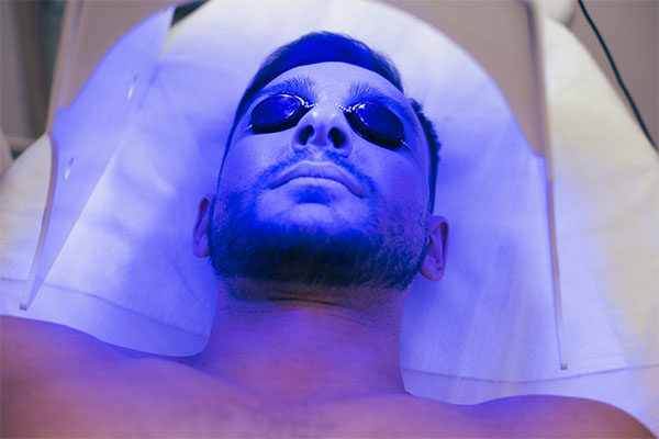 red-light-and-blue-light-therapy-red-therapy-light-light-therapy-treatment-before-after-blue-light-therapy-man-using-led-blue-light-therapy-with-eye-protection-on