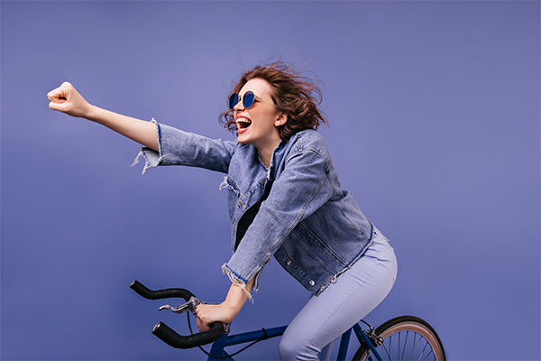 laughing-trendy-lady-sitting-bicycle-waving-hand-portrait-adorable-caucasian-female-bicyclist
