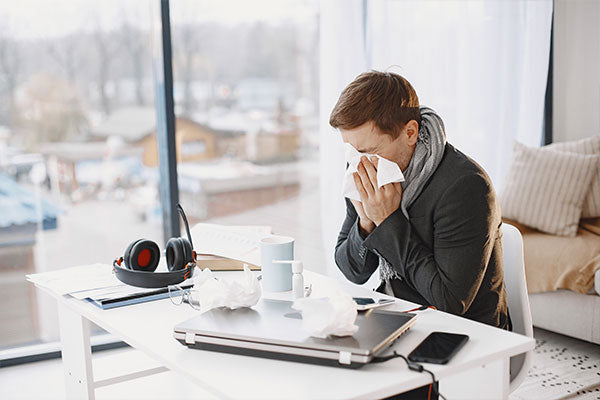 common-cold-and-flu-symptoms-man-sick-at-work