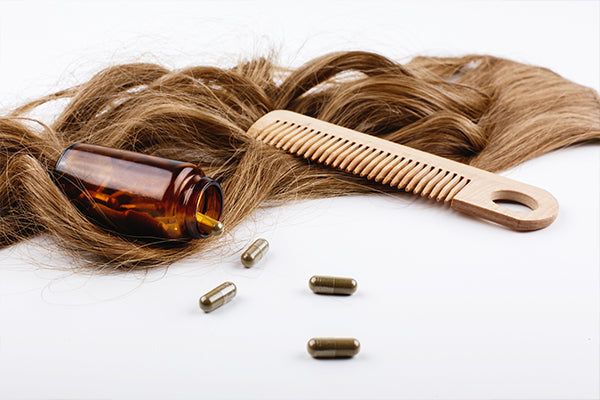 wooden-hair-comb-bottle-with-vitamins-lie-brown-hair-curls
