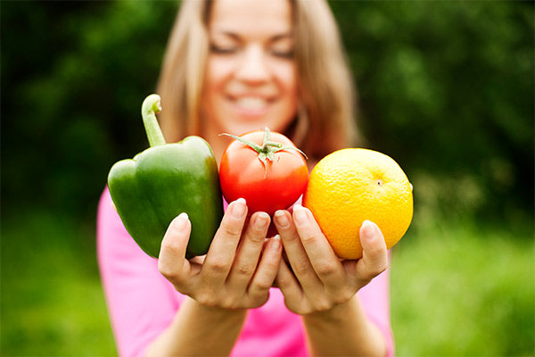 young-woman-holding-fruits-vegetables