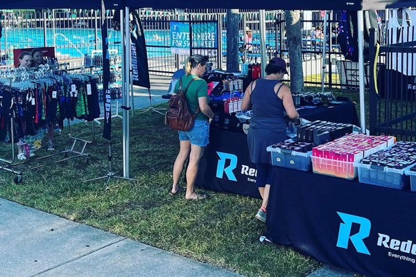 parents shopping for swim suits at Reddiset swim shop